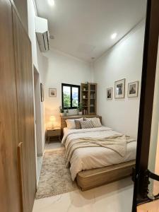 a bedroom with a large bed and a window at Sunrak House in Ðạo Thành