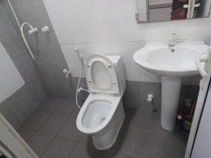 a bathroom with a toilet and a sink at MSM DIAMOND guesthouse 1 in Male City +5 photos