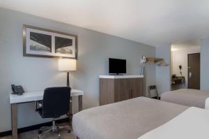 a hotel room with two beds and a desk and a computer at Quality Inn & Suites Silverdale Bangor-Keyport in Silverdale