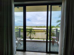 a room with a view of the ocean from a balcony at Calm House 4 Hoi An in Hoi An