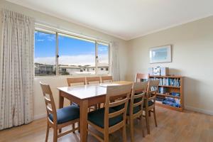 a dining room with a table and chairs and a window at Tahren Beach Getaway in Middleton