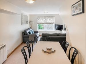 a living room with a table and a couch at Howgills Apartment 9 - Ukc9724 in Sedbergh