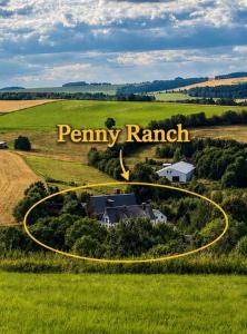 a house in a field with the words farmry ranch at Ferienwohnung Penny-Ranch in Zethau