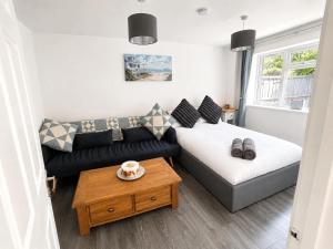 a small living room with a couch and a table at Neptune Nights in Pontnewynydd