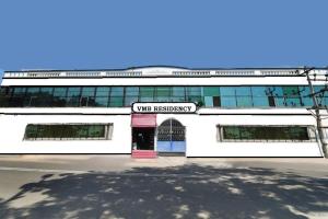 a white building with a sign that reads vine business at Pondy VMB Residency Starlight Hotels in Pondicherry
