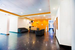 an office lobby with couches and a yellow wall at Pondy VMB Residency Starlight Hotels in Pondicherry