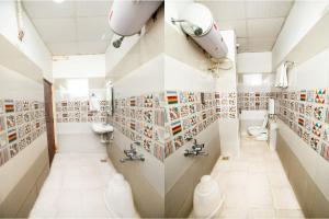 a bathroom with a bunch of pictures on the wall at Pondy VMB Residency Starlight Hotels in Pondicherry