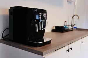 a microwave sitting on top of a kitchen counter at FeWo - An Fluss und Weinberg in Briedel