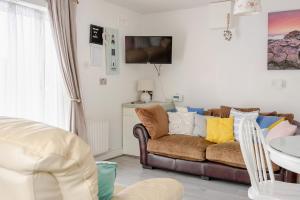 a living room with a couch and a table at Lorna's Apartment Self Catering Holiday Home in Milltown Malbay