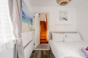 a small bedroom with a bed and a window at Lorna's Apartment Self Catering Holiday Home in Milltown Malbay