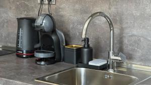 a kitchen sink with a coffee maker and a mixer at Studio Precious in Kranevo