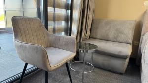 a room with a chair and a couch and a table at Studio Precious in Kranevo