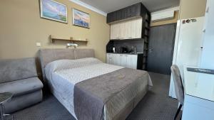 a small bedroom with a bed and a kitchen at Studio Precious in Kranevo +16 photos