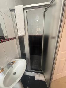 a bathroom with a sink and a shower at Crescent Bud in Durban +11 photos