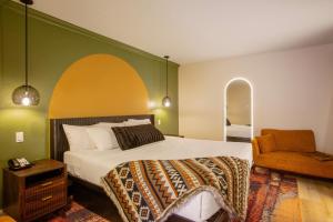 a bedroom with a bed and a chair at Arroyo Pinion Hotel, an Ascend Collection Hotel in Sedona
