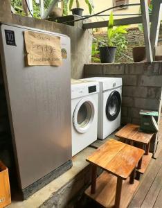 a washer and dryer sitting next to a table at Pont NongKhiaw in Nongkhiaw