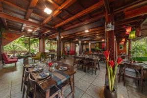 a dining room with wooden tables and chairs at Gateway Inn PuLuong in Pu Luong