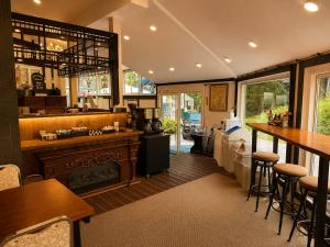 a restaurant with a bar and some tables and chairs at Hakuba Sun Valley Hotel in Hakuba