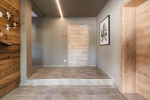 a hallway with a wooden door in a house at Appartementhaus Reiter in Altenmarkt im Pongau +130 photos
