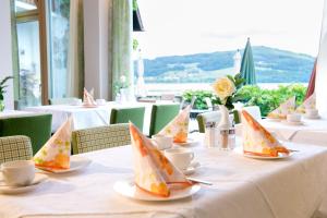 una mesa con tazas y platillos con botes de papel. en Hotel Walkner, en Seeham