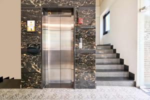 a elevator in a building with a staircase at Itsy Hotels NRM Residency - Near Mysore Palace in Mysore