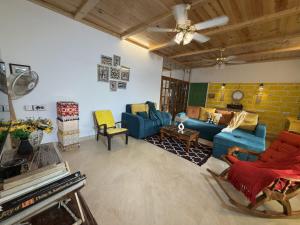 a living room with blue couches and a brick wall at SeaBreeze in Bārsiv