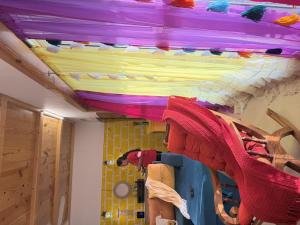 a room with a ceiling with a bunch of colorful sheets at SeaBreeze in Bārsiv +3 photos
