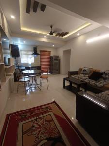 a living room with a couch and a table and chairs at Divin 2BHK Apartments 150 meter to temple in Guruvāyūr +7 photos