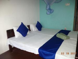 Postel nebo postele na pokoji v ubytování Raja174 Homestay