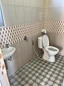 a bathroom with a toilet and a sink at Batur Happy House in Kintamani +27 photos