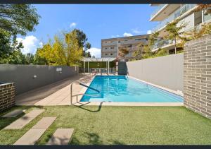 a swimming pool in the backyard of a building at Bold in Bruce - 1bd 1bth 1csp in Belconnen