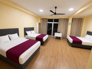 a hotel room with two beds and a ceiling fan at GRAND HOTEL ViLLA ROSA in Tingo María +41 photos
