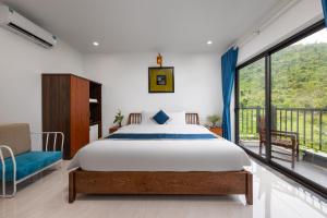 a bedroom with a bed and a large window at CATBA HEVEN HILLs in Xuan Dam +42 photos