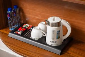 a coffee maker on a shelf in a room at CATBA HEVEN HILLs in Xuan Dam
