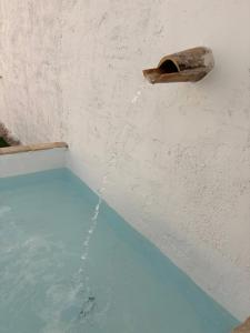 a pool of water pouring into a wall with a water fountain at Casa Purissima in Ontinyent