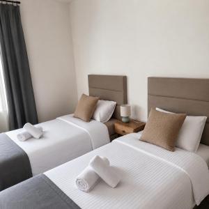 a room with two beds with towels on them at Nota Bene Pokoje Gościnne Polanica Zdrój in Polanica-Zdrój
