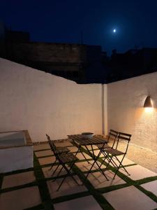 a table and chairs on a patio at night at Casa Purissima in Ontinyent