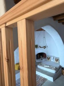 a bedroom with two beds in a room with an arch at Kamara since 1900 in Archangelos