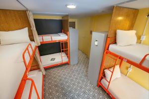 a small room with two bunk beds in it at Downtown Hostel HANOI & HA GIANG LOOP TOUR OFFICE in Hanoi