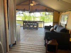 a living room with a couch and a table at Camping Les Chagnelles in Le Perrier