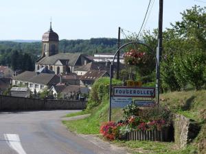 a town with a sign on the side of a road at La cabane de Claude in Fougerolles