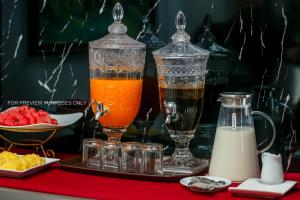 two glasses of juice and milk on a tray at Downtown Hostel HANOI & HA GIANG LOOP TOUR OFFICE in Hanoi
