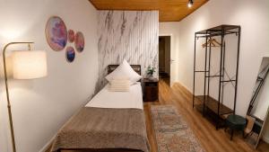 a small bedroom with a bed and a lamp at Villa Johannes in Warmensteinach