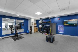 a room with a gym with blue walls at Hampton Inn Henderson in Henderson