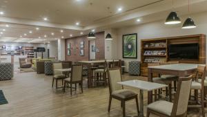 a restaurant with tables and chairs and a tv at Holiday Inn Express Mexico- Toreo by IHG in Mexico City