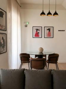 a living room with a table and chairs and a couch at Modern Designer Apartment Private Yard in Hamrun