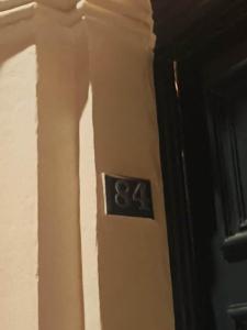 a clock on the side of a wall at Modern Designer Apartment Private Yard in Hamrun +3 photos