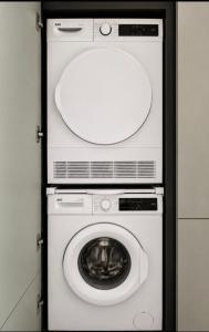 a washer and dryer in a door with a mirror at Modern Designer Apartment Private Yard in Hamrun