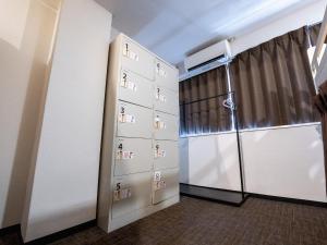 a room with a closet and a door with boxes at Guesthouse Sign in Kyoto