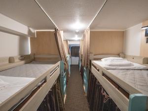 a room with two bunk beds in a train at Guesthouse Sign in Kyoto +27 photos